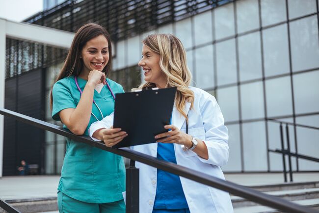 two female nurses talking to each other