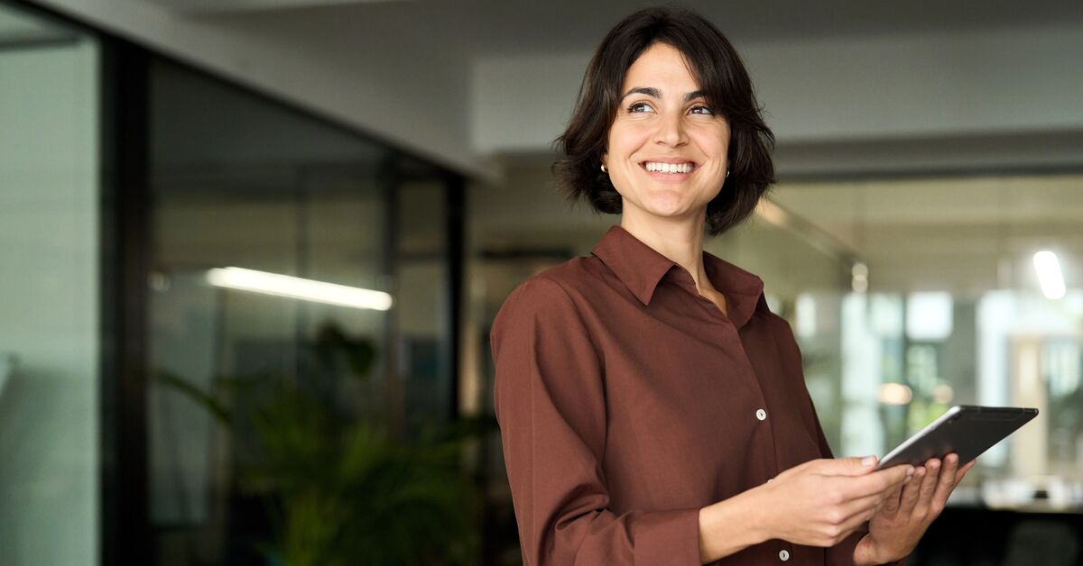 female executive leader holding tab at work