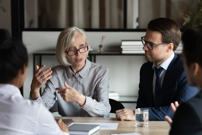 teacher explaining work process to new employees