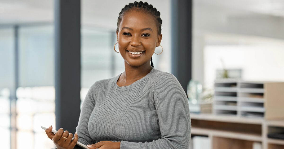 social work graduate holding her tablet