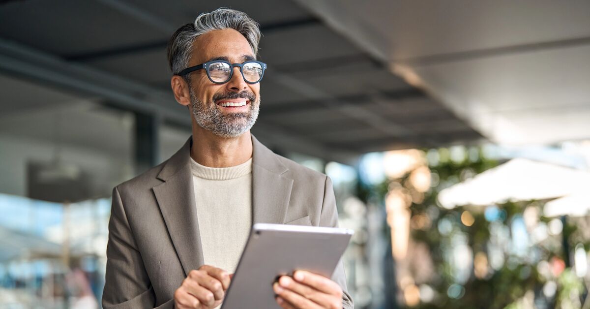 middle aged professional business man using digital tablet